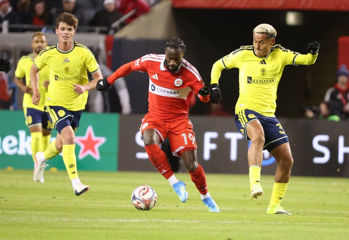 Apr 4, 2026; Chicago, Illinois, USA; Chicago Fire FC forward Jonathan Bamba (19) and Nashville SC defender Andy Najar (31) battle for control of the ball during the first half at Soldier Field. Mandatory Credit: Talia Sprague-Imagn Images