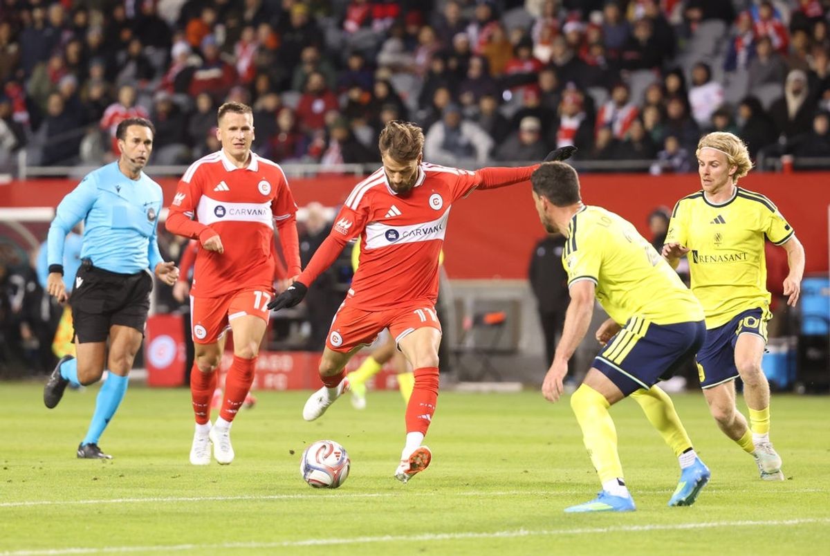 Apr 4, 2026; Chicago, Illinois, USA; Chicago Fire FC midfielder Philip Zinckernagel (11) takes a shot on goal during the first half against the Nashville SC at Soldier Field. Mandatory Credit: Talia Sprague-Imagn Images