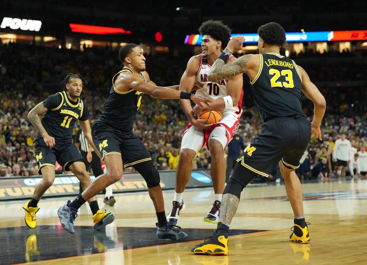 Apr 4, 2026; Indianapolis, IN, USA;  Arizona Wildcats forward Koa Peat (10) is defended by Michigan Wolverines guard Nimari Burnett (4) and Michigan Wolverines forward Yaxel Lendeborg (23) in the second half during a semifinal of the Final Four of the men's 2026 NCAA Tournament at Lucas Oil Stadium. Mandatory Credit: Robert Deutsch-Imagn Images