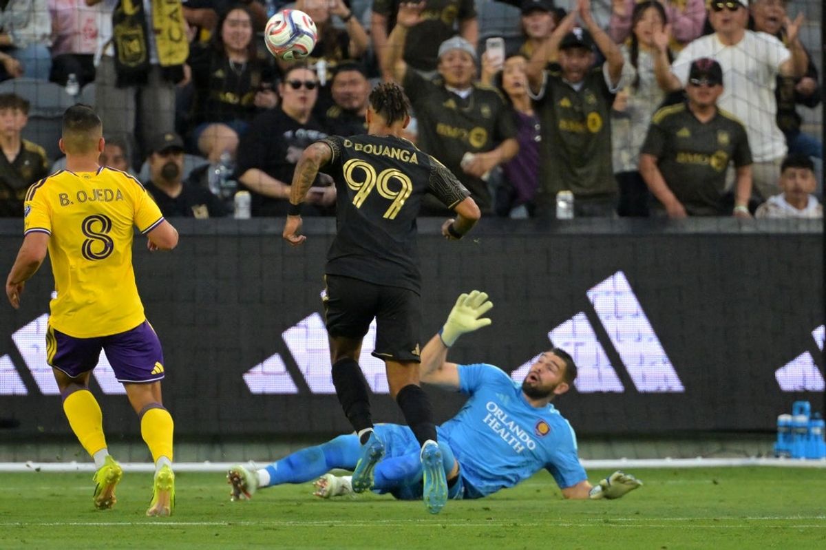 Apr 4, 2026; Los Angeles, California, USA; LAFC forward Denis Bouanga (99) scores past Orlando City goalkeeper Maxime Crépeau (71) in the first half at BMO Stadium. Mandatory Credit: Jayne Kamin-Oncea-Imagn Images