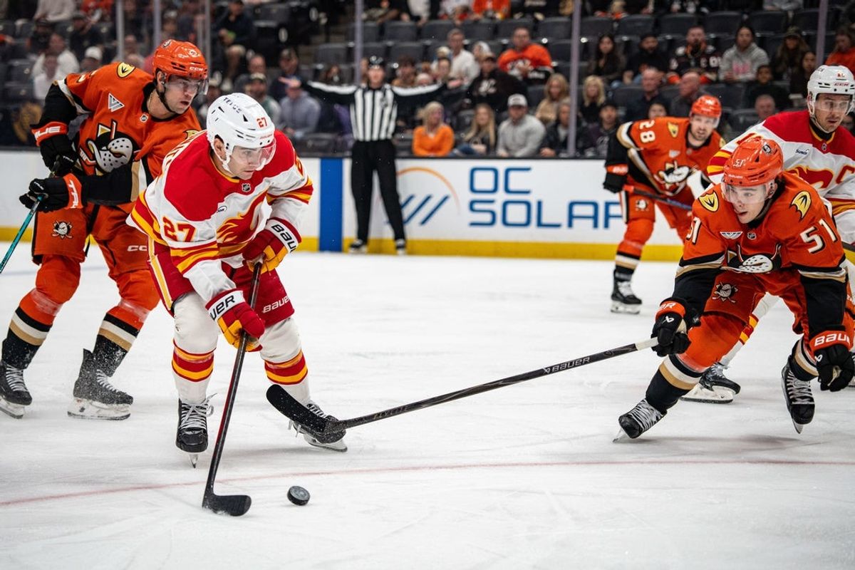 Apr 4, 2026; Anaheim, California, USA; Calgary Flames right wing Matt Coronato (27) take a shot on goal against Anaheim Ducks defenseman Olen Zellweger (51) during the first period at Honda Center. Mandatory Credit: Corinne Votaw-Imagn Images