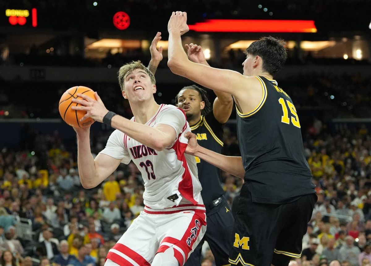 Apr 4, 2026; Indianapolis, IN, USA;  Arizona Wildcats center Motiejus Krivas (13) shoots against Michigan Wolverines center Aday Mara (15) in the second half during a semifinal of the Final Four of the men's 2026 NCAA Tournament at Lucas Oil Stadium. Mandatory Credit: Robert Deutsch-Imagn Images