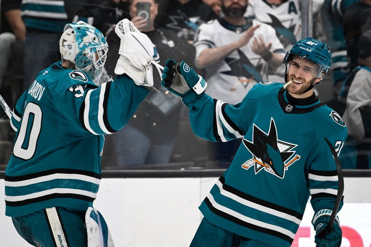 Apr 4, 2026; San Jose, California, USA; San Jose Sharks center Alexander Wennberg (21) celebrates their goal with goaltender Yaroslav Askarov (30) against the Nashville Predators in the third period at SAP Center at San Jose. Mandatory Credit: Eakin Howard-Imagn Images