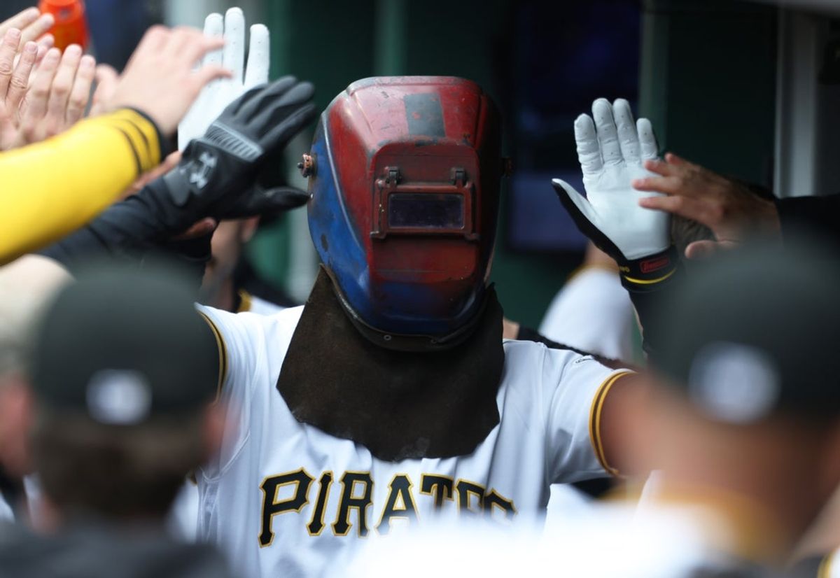 Apr 5, 2026; Pittsburgh, Pennsylvania, USA;  Pittsburgh Pirates fright fielder Ryan O'Hearn (29) celebrates his two run home run in the dugout while wearing a welders hood against the Baltimore Orioles during the first inning at PNC Park. Mandatory Credit: Charles LeClaire-Imagn Images