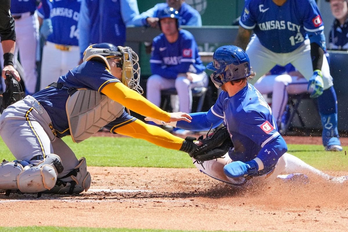 Apr 5, 2026; Kansas City, Missouri, USA; Milwaukee Brewers catcher William Contreras (24) tags out Kansas City Royals shortstop Bobby Witt Jr. (7) at home plate during the third inning at Kauffman Stadium. Mandatory Credit: Denny Medley-Imagn Images