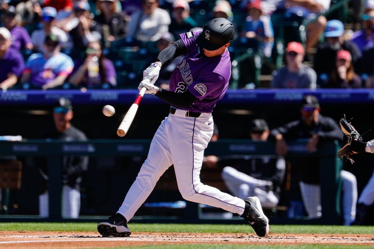 Apr 5, 2026; Denver, Colorado, USA; Colorado Rockies right fielder Mickey Moniak (22) hits a solo home run in the first inning against the Philadelphia Phillies at Coors Field. Mandatory Credit: Isaiah J. Downing-Imagn Images