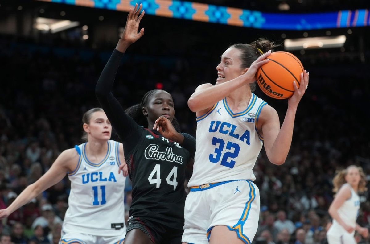 UCLA Bruins forward Angela Dugalic (32) grabs a rebound over South Carolina Gamecocks guard Agot Makeer (44) during their NCAA women's basketball national championship game at Mortgage Matchup Center in Phoenix on April 5, 2026.
