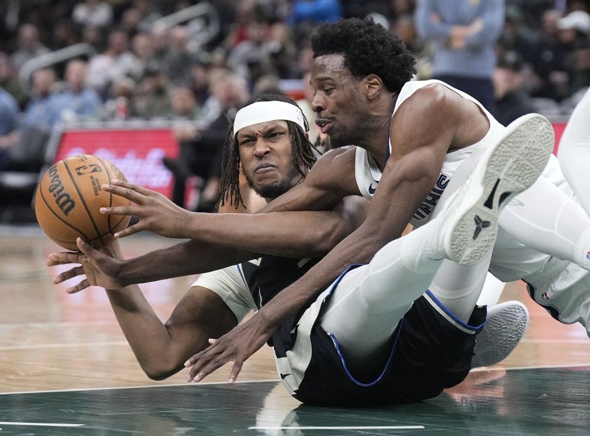 Apr 5, 2026; Milwaukee, Wisconsin, USA; Milwaukee Bucks center/forward Myles Turner (3) and Memphis Grizzlies forward Toby Okani (5) battle for a loose ballt Fiserv Forum. Mandatory Credit: Michael McLoone-Imagn Images