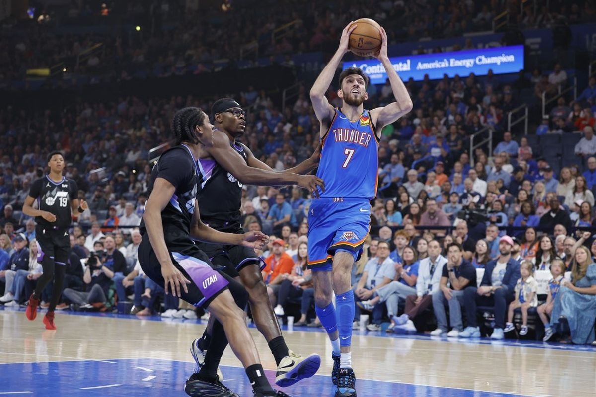 Apr 5, 2026; Oklahoma City, Oklahoma, USA; Oklahoma City Thunder center Chet Holmgren (7) drives to the basket beside Utah Jazz center Oscar Tshiebwe (34) and forward Cody Williams (5) during the first quarter at Paycom Center. Mandatory Credit: Alonzo Adams-Imagn Images