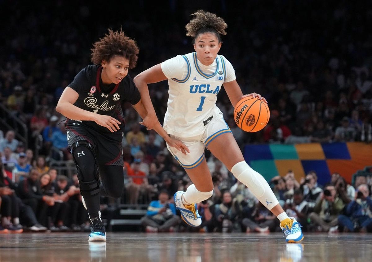 UCLA Bruins guard Kiki Rice (1) drives past South Carolina Gamecocks guard Maddy McDaniel (1) during the NCAA women's basketball national championship at Mortgage Matchup Center in Phoenix on April 5, 2026.