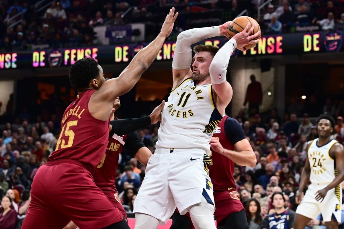 Apr 5, 2026; Cleveland, Ohio, USA; Indiana Pacers center Micah Potter (11) is defended by Cleveland Cavaliers guard Donovan Mitchell (45) during the second half at Rocket Arena. Mandatory Credit: Ken Blaze-Imagn Images