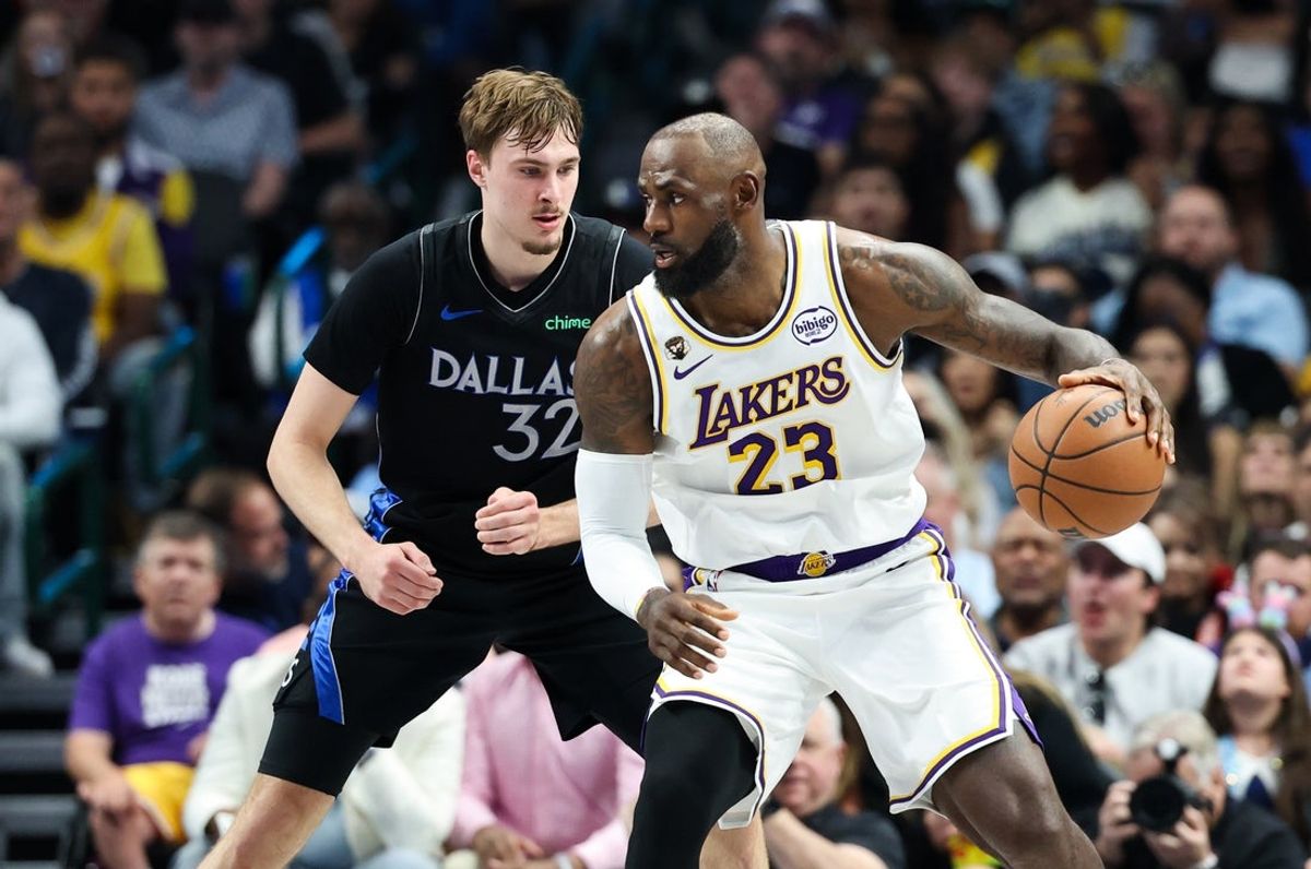 Apr 5, 2026; Dallas, Texas, USA;  Los Angeles Lakers forward LeBron James (23) controls the ball as  Dallas Mavericks forward Cooper Flagg (32) defends during the first half at American Airlines Center. Mandatory Credit: Kevin Jairaj-Imagn Images