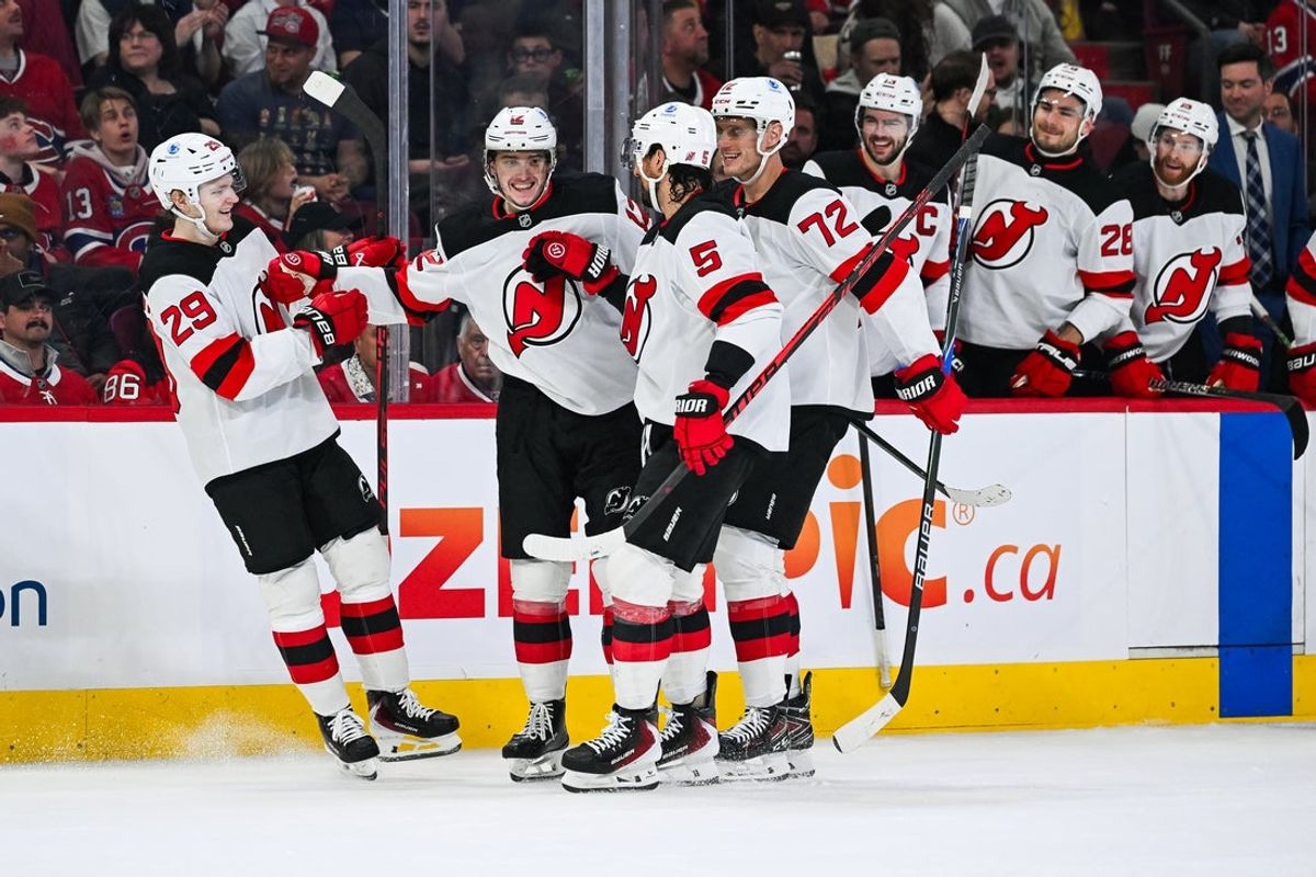 Apr 5, 2026; Montreal, Quebec, CAN; New Jersey Devils center Cody Glass (12) celebrates with his teammates his goal against the Montreal Canadiens during the second period at Bell Centre. Mandatory Credit: David Kirouac-Imagn Images