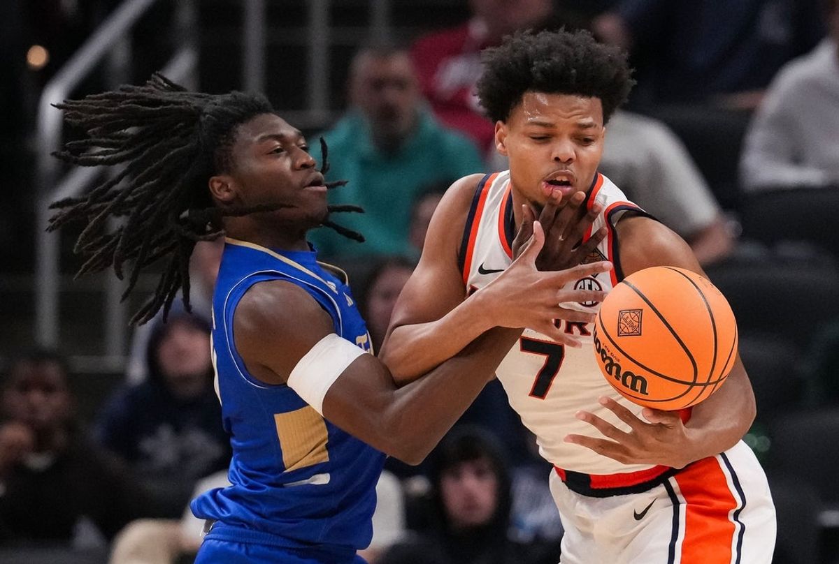 Auburn Tigers guard Keyshawn Hall (7) ball is tipped away by Tulsa Golden Hurricane guard Ade Popoola (0) on Sunday, April 5, 2026, during the NIT men's basketball championship game at Gainbridge Fieldhouse in Indianapolis.