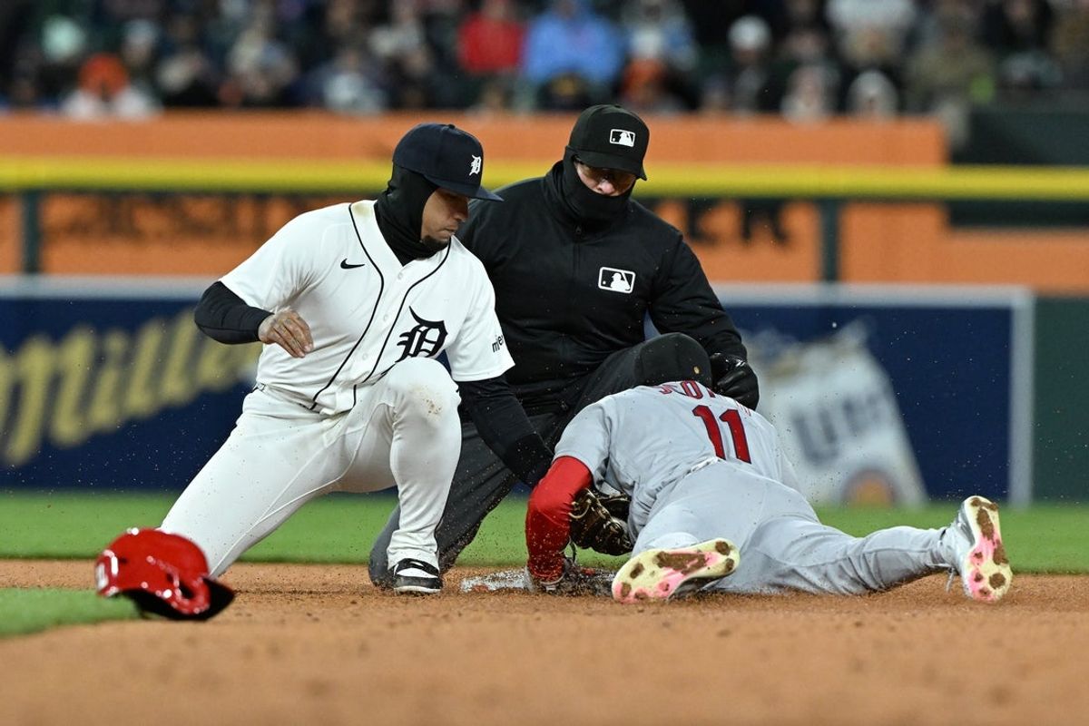 Apr 5, 2026; Detroit, Michigan, USA;  St. Louis Cardinals center fielder Victor Scott II (11) gets tagged out by Detroit Tigers shortstop Javier Báez (28) trying to steal second base in the ninth inning at Comerica Park. Mandatory Credit: Lon Horwedel-Imagn Images