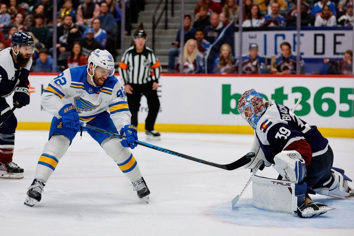 Apr 5, 2026; Denver, Colorado, USA; St. Louis Blues left wing Jonathan Drouin (92) attempts a shot against Colorado Avalanche goaltender MacKenzie Blackwood (39) in the first period at Ball Arena. Mandatory Credit: Isaiah J. Downing-Imagn Images