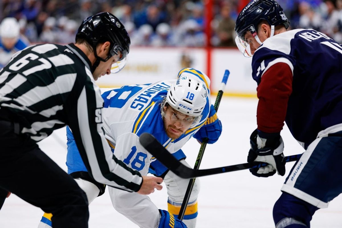 Apr 5, 2026; Denver, Colorado, USA; St. Louis Blues center Robert Thomas (18) faces off against Colorado Avalanche center Brock Nelson (11) as linesman Travis Gawryletz (67) drops the puck in the third period at Ball Arena. Mandatory Credit: Isaiah J. Downing-Imagn Images