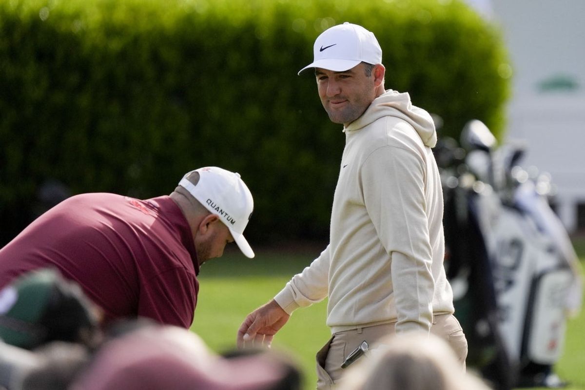 Scottie Scheffler talks to Brandon Holtz at the practice facility during a practice round for the Masters Tournament at Augusta National Golf Club. Mandatory Credit: Katie Goodale-Imagn Images