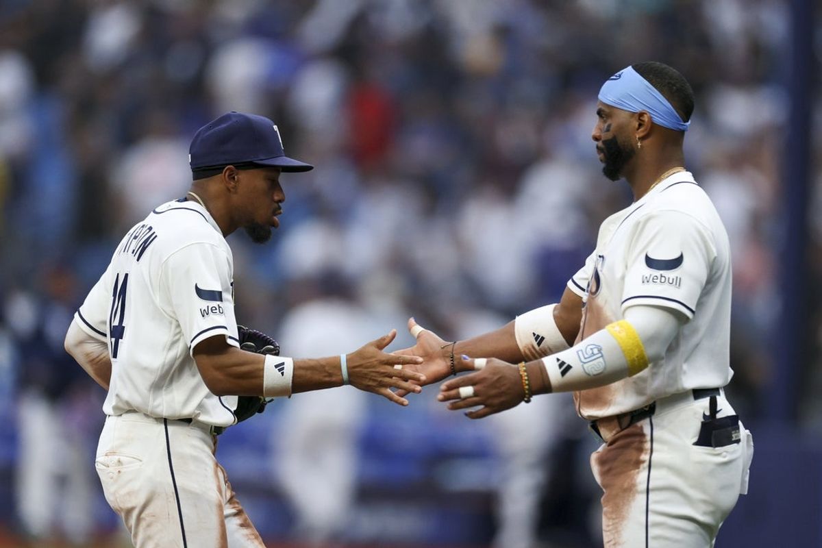 Apr 6, 2026; St. Petersburg, Florida, USA; Tampa Bay Rays center fielder Chandler Simpson (14) and designated hitter Yandy Diaz (2) react after beating the Chicago Cubs at Tropicana Field. Mandatory Credit: Nathan Ray Seebeck-Imagn Images