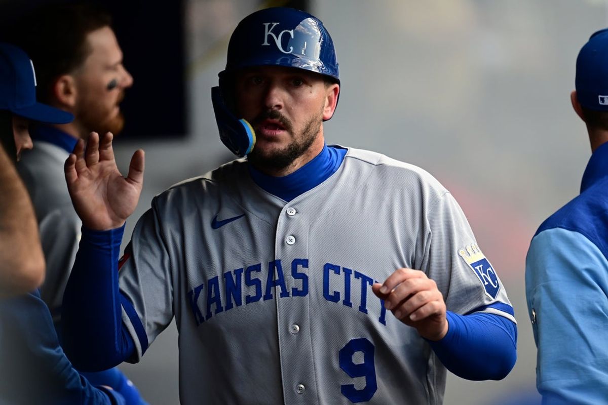 Apr 6, 2026; Cleveland, Ohio, USA; Kansas City Royals first baseman Vinnie Pasquantino (9) is congratulated in the dugout after scoring a run on an RBI single by Kansas City Royals second baseman Jonathan India (6) during the fourth inning against the Cleveland Guardians at Progressive Field. Mandatory Credit: David Dermer-Imagn Images