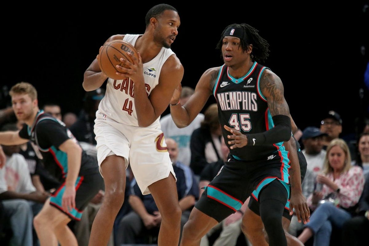 Apr 6, 2026; Memphis, Tennessee, USA; Cleveland Cavaliers center Evan Mobley (4) handles the ball as Memphis Grizzlies forward GG Jackson (45) defends during the first quarter at FedExForum. Mandatory Credit: Petre Thomas-Imagn Images