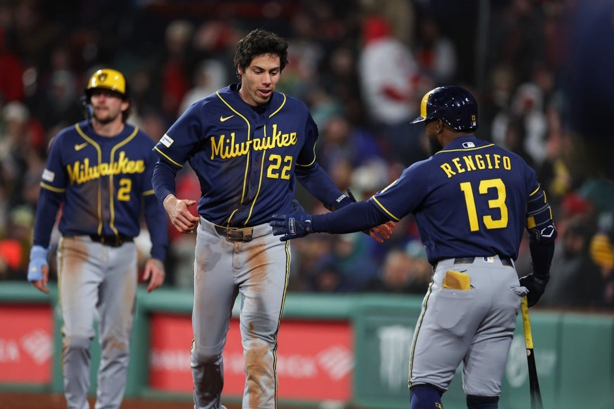 Apr 6, 2026; Boston, Massachusetts, USA; Milwaukee Brewers left fielder Christian Yelich (22) celebrates with Milwaukee Brewers second baseman Luis Rengifo (13) during the eighth inning against the Boston Red Sox at Fenway Park. Mandatory Credit: Paul Rutherford-Imagn Images