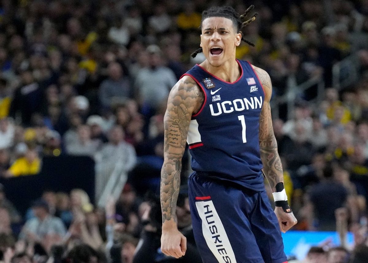 UConn Huskies guard Solo Ball (1) reacts to a made three point basket Monday, April 6, 2026, during the NCAA men's basketball tournament national championship game against the Michigan Wolverines at Lucas Oil Stadium in Indianapolis.