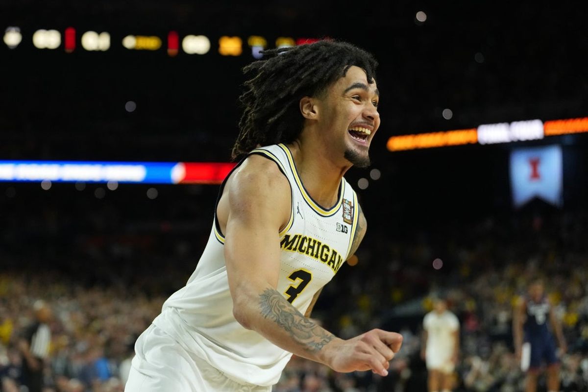 Apr 6, 2026; Indianapolis, IN, USA; Michigan Wolverines guard Elliot Cadeau (3) celebrates after their win against the UConn Huskies in the national championship of the Final Four of the men's 2026 NCAA Tournament between the  and the Michigan Wolverines at Lucas Oil Stadium. Mandatory Credit: Bob Donnan-Imagn Images
