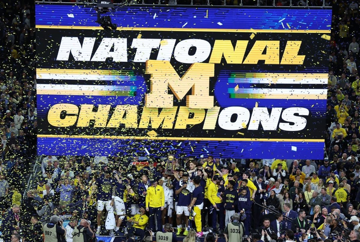 Apr 6, 2026; Indianapolis, IN, USA; Michigan Wolverines head coach Dusty May celebrates with the trophy after defeating the UConn Huskies in the national championship of the Final Four of the men's 2026 NCAA Tournament at Lucas Oil Stadium. Mandatory Credit: Trevor Ruszkowski-Imagn Images