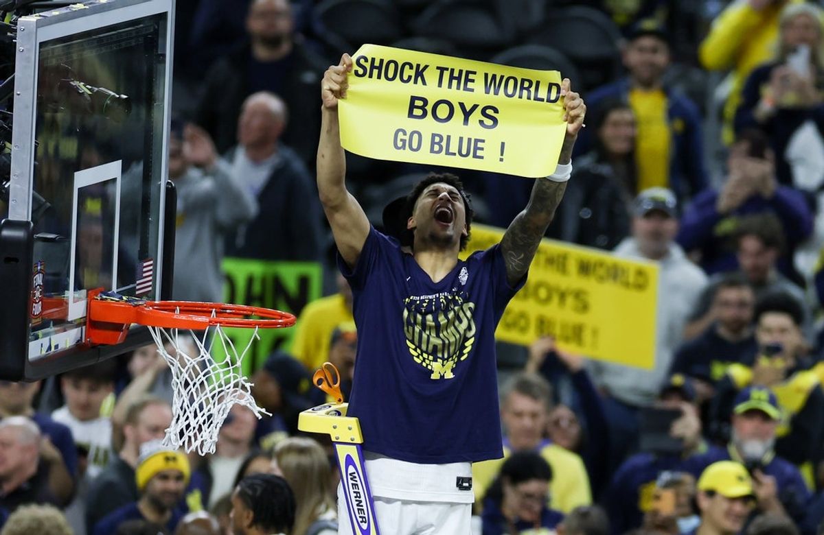 Apr 6, 2026; Indianapolis, IN, USA; Michigan Wolverines forward Yaxel Lendeborg (23) cuts down the net after defeating the UConn Huskies in the national championship of the Final Four of the men's 2026 NCAA Tournament at Lucas Oil Stadium. Mandatory Credit: Trevor Ruszkowski-Imagn Images