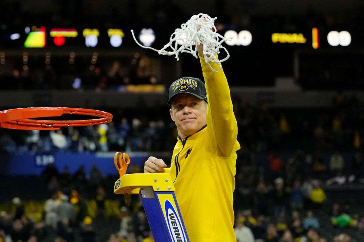 6 de abril de 2026; Indianápolis, IN, EUA; O técnico do Michigan Wolverines, Dusty May, acena para os fãs depois de cortar a rede após sua vitória contra o UConn Huskies no campeonato nacional da Final Four do torneio masculino da NCAA de 2026 entre o Michigan Wolverines e o Michigan Wolverines no Lucas Oil Stadium. Crédito obrigatório: Bob Donnan-Imagn Images