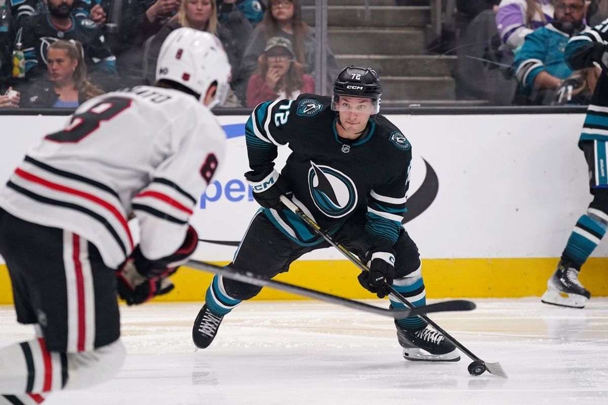 Apr 6, 2026; San Jose, California, USA;  San Jose Sharks left wing William Eklund (72) controls the puck against Chicago Blackhawks center Ryan Donato (8) in the third period at SAP Center at San Jose. Mandatory Credit: David Gonzales-Imagn Images