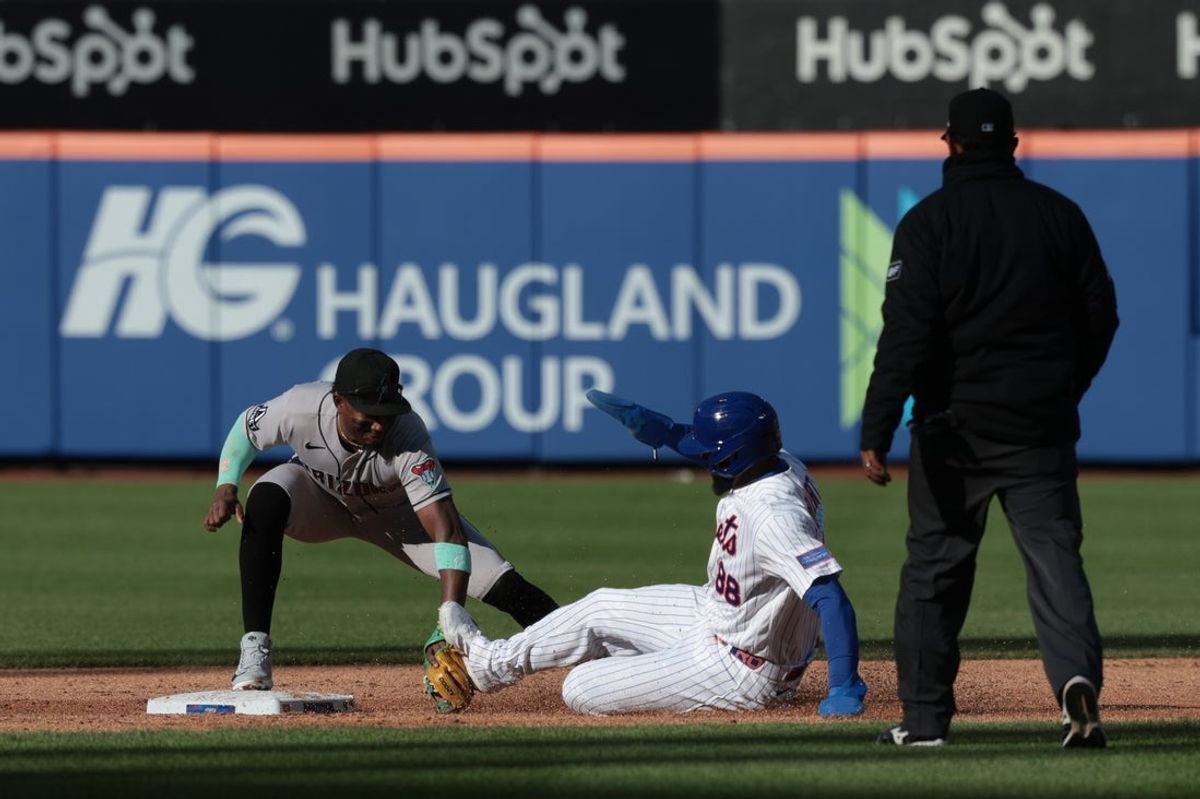 Apr 7, 2026; New York City, New York, USA;  New York Mets center fielder Luis Robert Jr. (88) is tagged out at second base by Arizona Diamondbacks shortstop Geraldo Perdomo (2) during the third inning at Citi Field. Mandatory Credit: Vincent Carchietta-Imagn Images