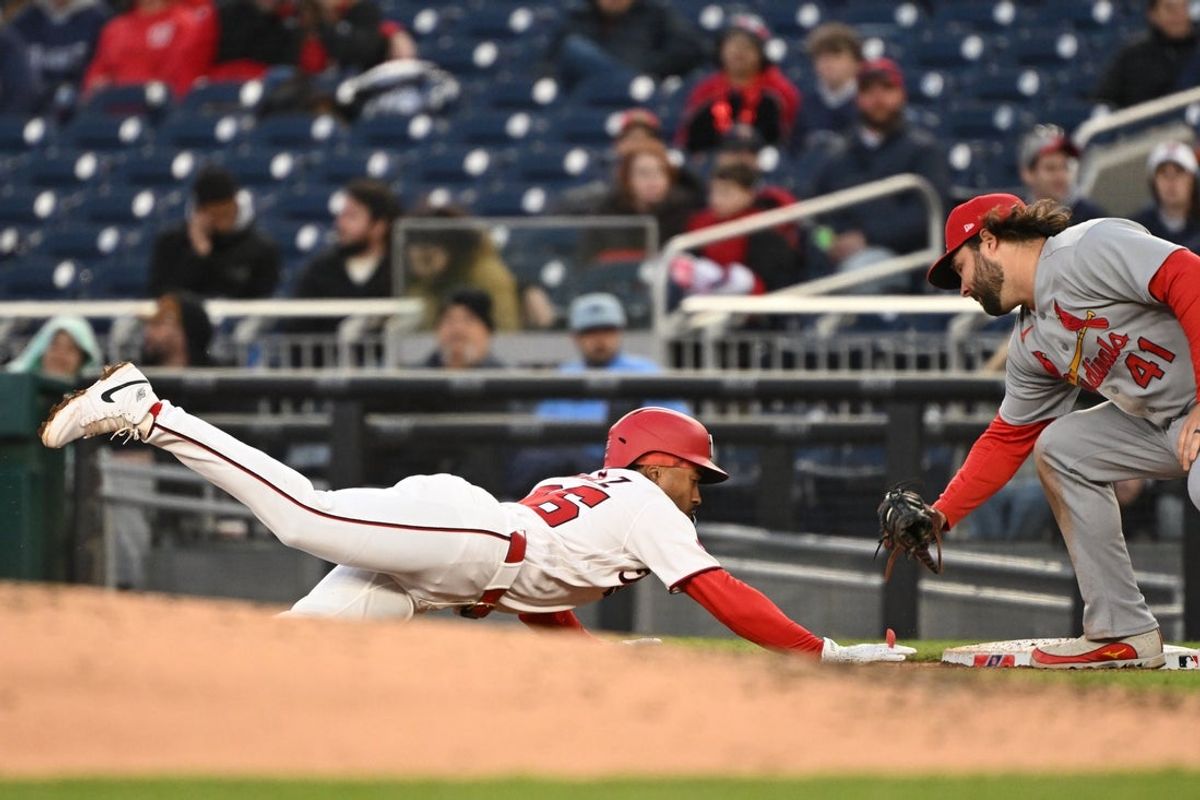 Apr 7, 2026; Washington, District of Columbia, USA; Washington Nationals shortstop Nasim Nunez (26) dives back to first base in front of St. Louis Cardinals first baseman Alec Burleson (41) during a pick off attempt during the second inning at Nationals Park. Mandatory Credit: Rafael Suanes-Imagn Images
