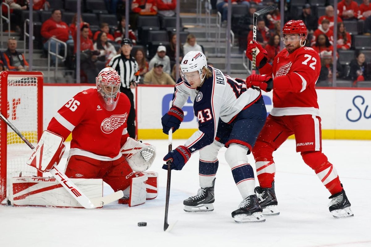 Apr 7, 2026; Detroit, Michigan, USA;  Columbus Blue Jackets left wing Danton Heinen (43) tries to score on Detroit Red Wings goaltender John Gibson (36) defended by defenseman Justin Faulk (72) in the first period at Little Caesars Arena. Mandatory Credit: Rick Osentoski-Imagn Images