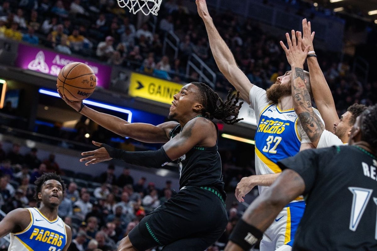 Apr 7, 2026; Indianapolis, Indiana, USA; Minnesota Timberwolves guard Ayo Dosunmu (13) shoots the ball while Indiana Pacers center Jay Huff (32) defends in the first half at Gainbridge Fieldhouse. Mandatory Credit: Trevor Ruszkowski-Imagn Images