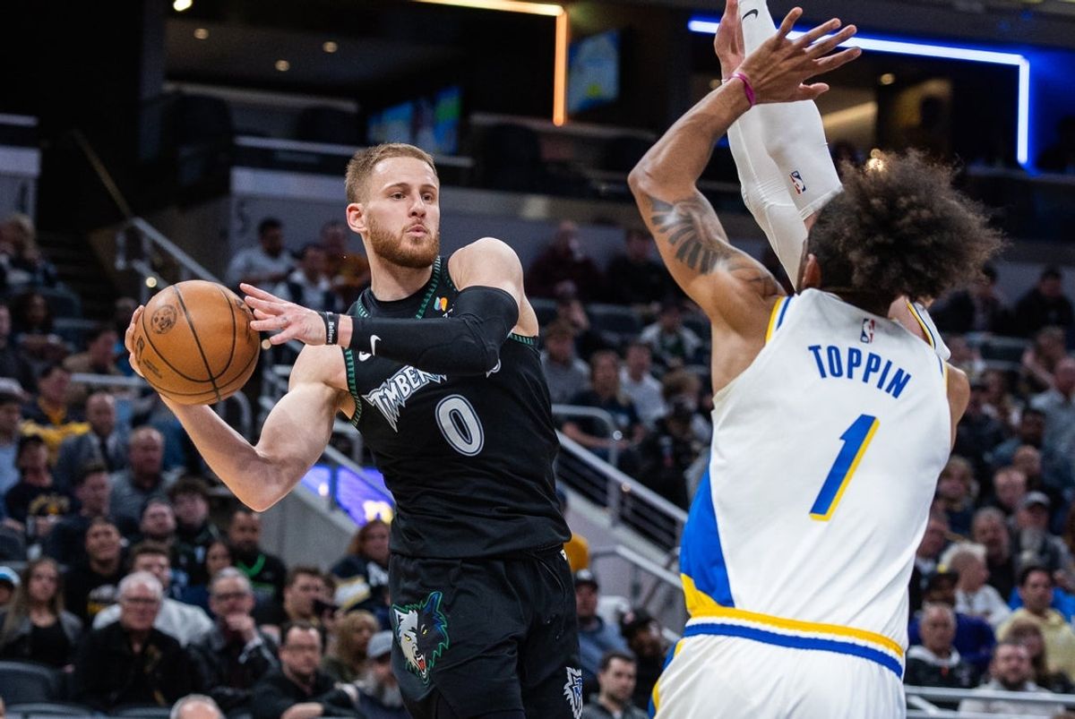 Apr 7, 2026; Indianapolis, Indiana, USA; Minnesota Timberwolves guard Donte DiVincenzo (0) passes the ball while Indiana Pacers forward Obi Toppin (1) defends in the first half at Gainbridge Fieldhouse. Mandatory Credit: Trevor Ruszkowski-Imagn Images