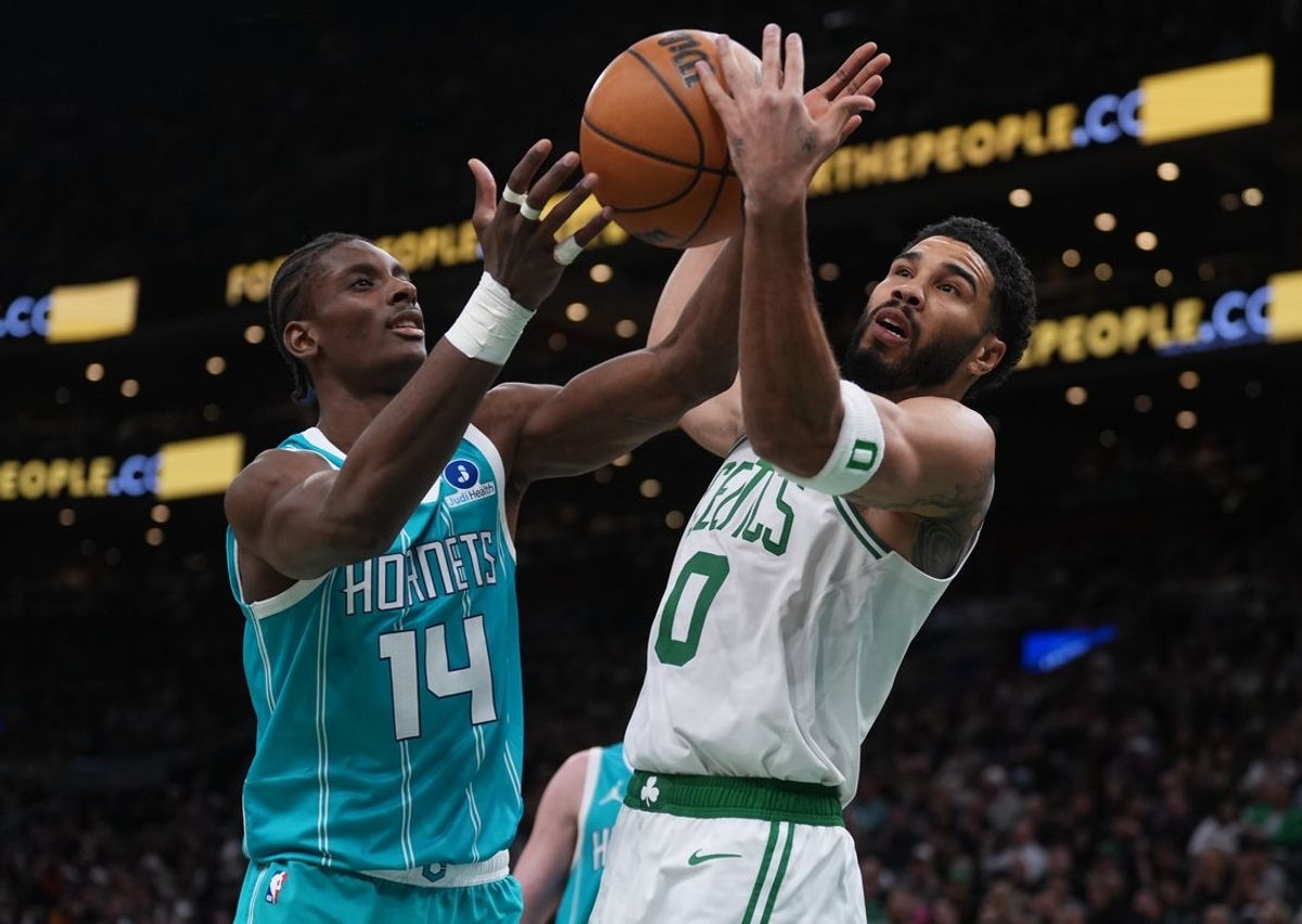 Apr 7, 2026; Boston, Massachusetts, USA; Boston Celtics forward Jayson Tatum (0) and Charlotte Hornets F/C Moussa Diabate (14) work for the ball in the second quarter at TD Garden. Mandatory Credit: David Butler II-Imagn Images