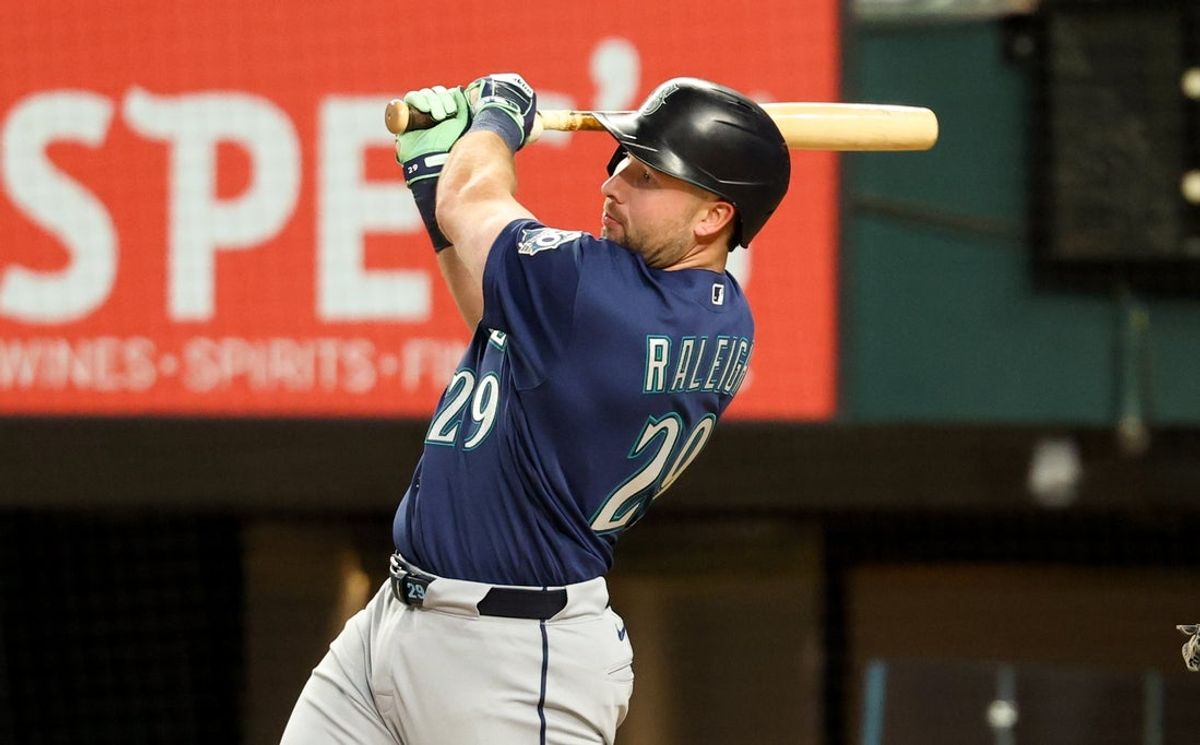 Apr 7, 2026; Arlington, Texas, USA; Seattle Mariners catcher Cal Raleigh (29) hits an rbi single during the fifth inning against the Texas Rangers at Globe Life Field. Mandatory Credit: Kevin Jairaj-Imagn Images