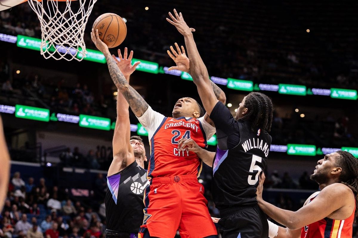 Apr 7, 2026; New Orleans, Louisiana, USA; New Orleans Pelicans guard Jordan Hawkins (24) shoots the ball against Utah Jazz forward Cody Williams (5) during the first half at Smoothie King Center. Mandatory Credit: Stephen Lew-Imagn Images
