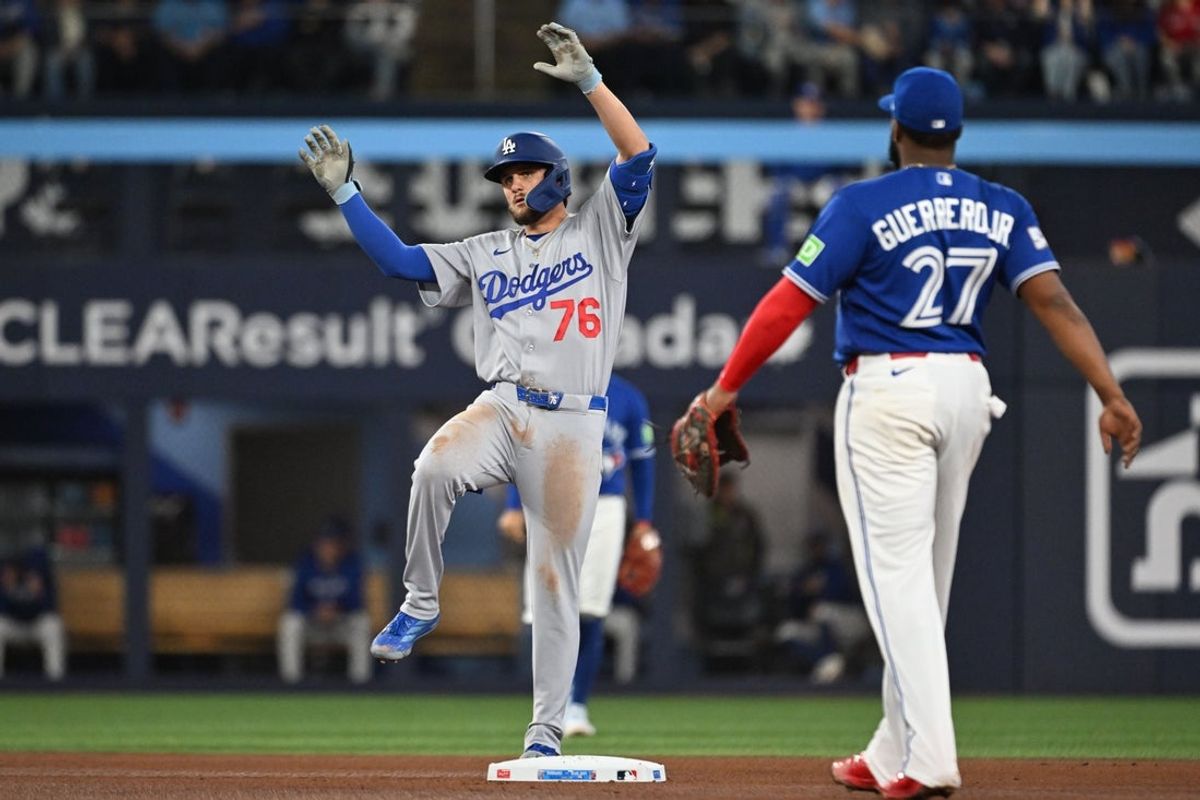Apr 7, 2026; Toronto, Ontario, CAN;  Los Angeles Dodgers second baseman Alex Freeland (76) reacts after hitting a double against the Toronto Blue Jays in the seventh inning at Rogers Centre. Mandatory Credit: Dan Hamilton-Imagn Images