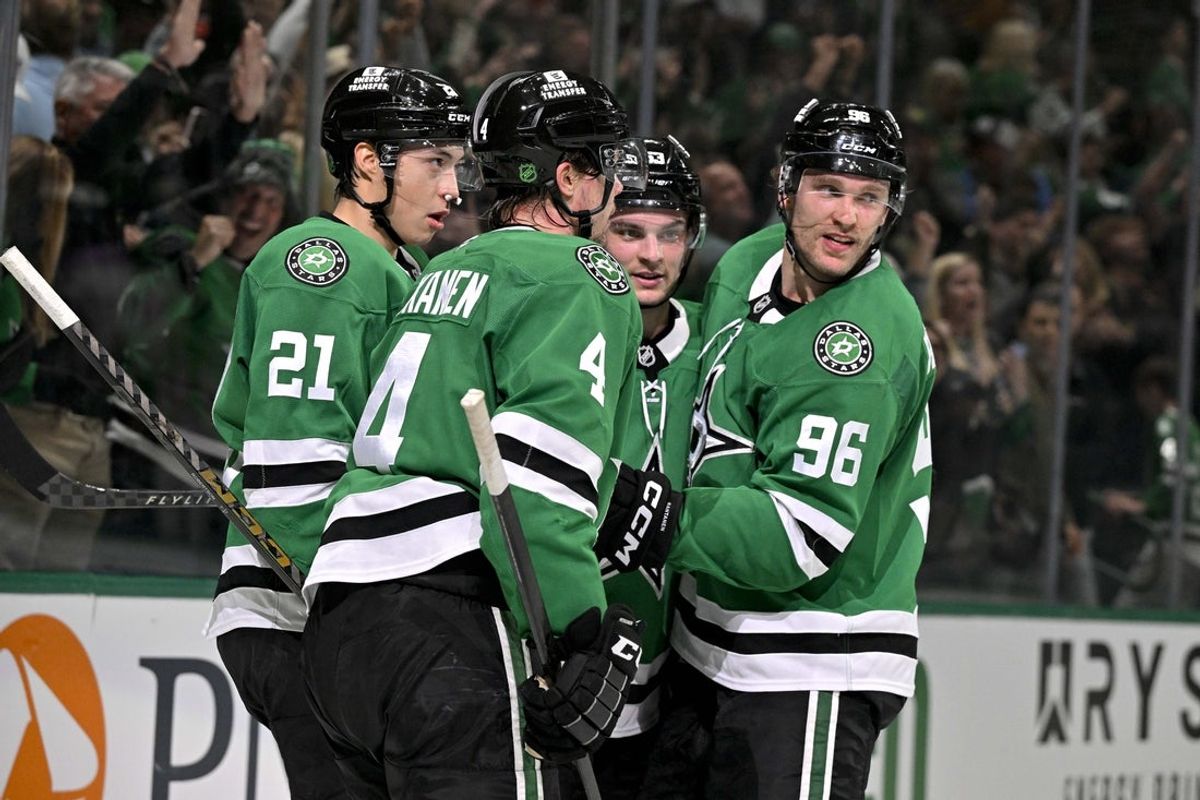 Apr 7, 2026; Dallas, Texas, USA; Dallas Stars defenseman Miro Heiskanen (4) and left wing Jason Robertson (21) and center Wyatt Johnston (53) and right wing Mikko Rantanen (96) celebrate after Johnston scores the game winning power-play goal against Calgary Flames goaltender Devin Cooley (not pictured) during the overtime period at the American Airlines Center. Mandatory Credit: Jerome Miron-Imagn Images