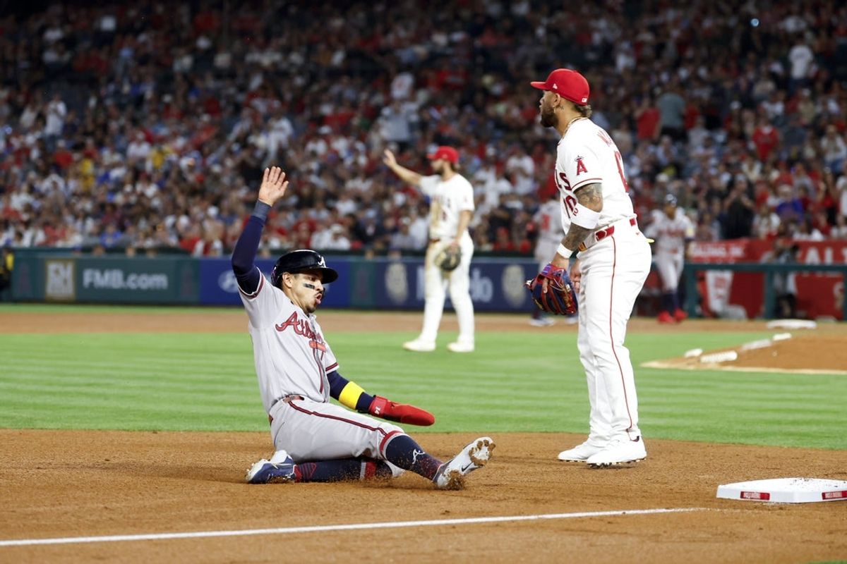 Apr 7, 2026; Anaheim, California, USA; Atlanta Braves second baseman Mauricio Dubón (14) slides into third base during the fourth inning against the Los Angeles Angels at Angel Stadium. Mandatory Credit: William Navarro-Imagn Images