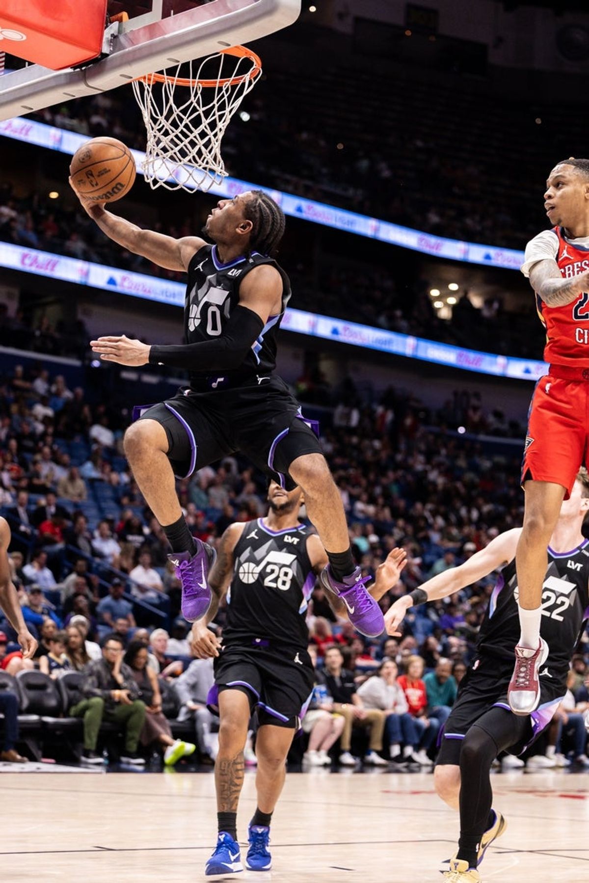 Apr 7, 2026; New Orleans, Louisiana, USA; Utah Jazz guard Kennedy Chandler (0) shoots the ball against New Orleans Pelicans guard Jordan Hawkins (24) during the second half at Smoothie King Center. Mandatory Credit: Stephen Lew-Imagn Images