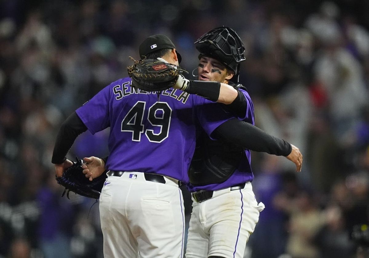 Apr 7, 2026; Denver, Colorado, USA; Colorado Rockies relief pitcher Antonio Senzatela (49) and catcher Brett Sullivan (26) celebrate defeating the Houston Astros in the inning at Coors Field. Mandatory Credit: Ron Chenoy-Imagn Images