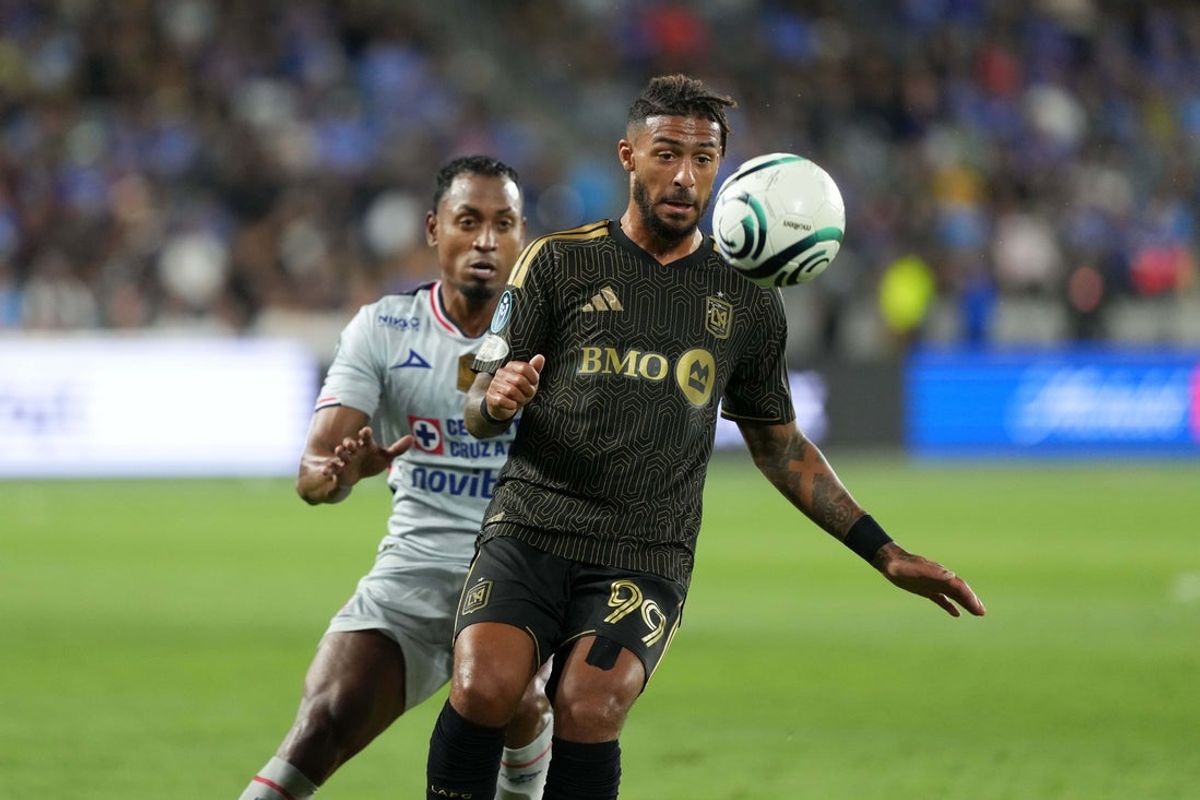Apr 7, 2026; Los Angeles, CA, USA; LAFC forward Denis Bouanga (99) battles for the ball with Cruz Azul defender Willer Ditta (4) in the first half of a Concacaf Champions Cup quarterfinal at BMO Stadium. Mandatory Credit: Kirby Lee-Imagn Images