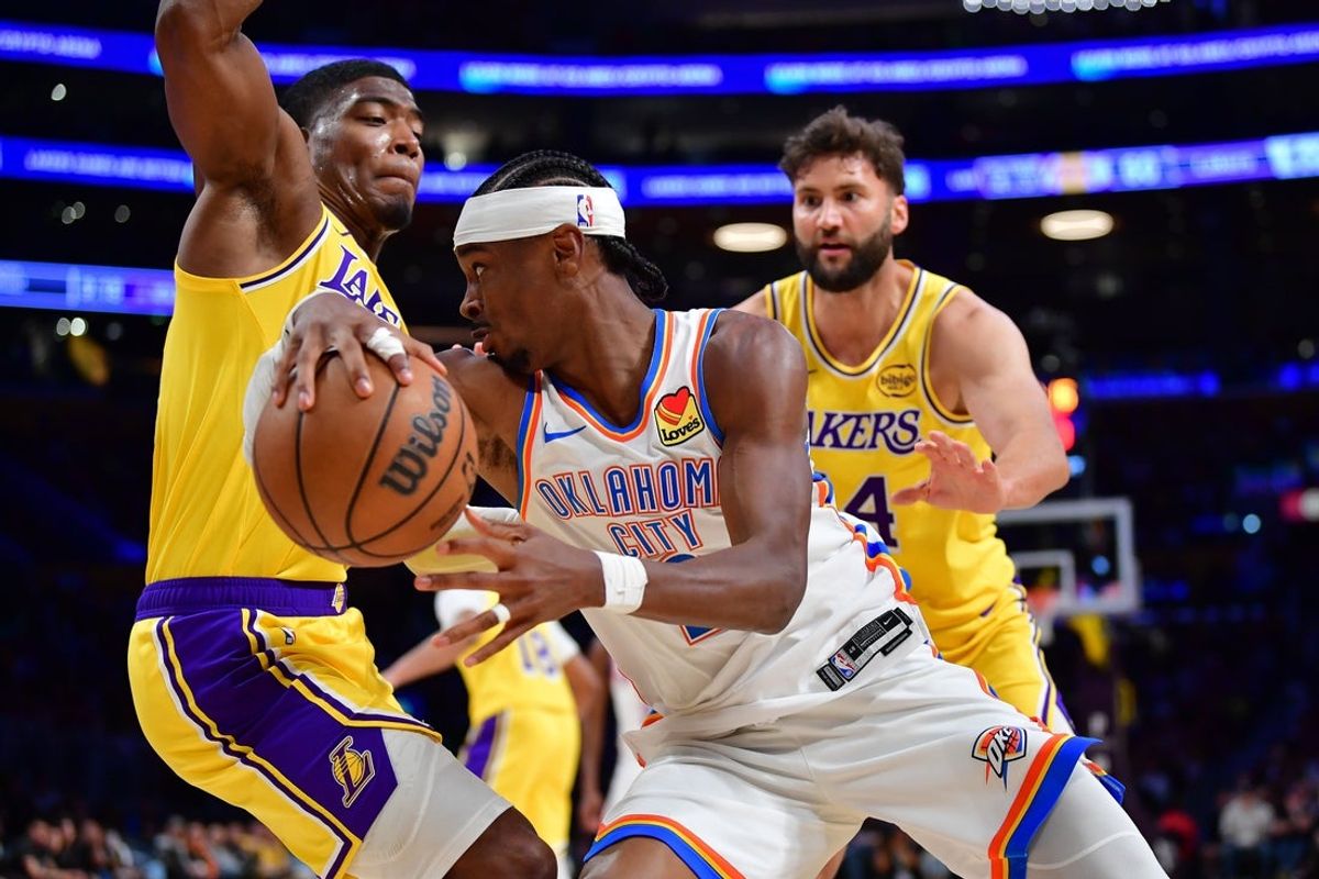 April 7, 2026; Los Angeles, California, USA; Oklahoma City Thunder guard Shai Gilgeous-Alexander (2) moves the ball against Los Angeles Lakers forward Rui Hachimura (28) during the second half at Crypto.com Arena. Mandatory Credit: Gary A. Vasquez-Imagn Images