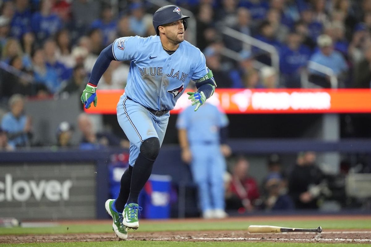 Apr 8, 2026; Toronto, Ontario, CAN; Toronto Blue Jays designated hitter George Springer (4) hits a one run double against the Los Angeles Dodgers during the seventh inning at Rogers Centre. Mandatory Credit: John E. Sokolowski-Imagn Images