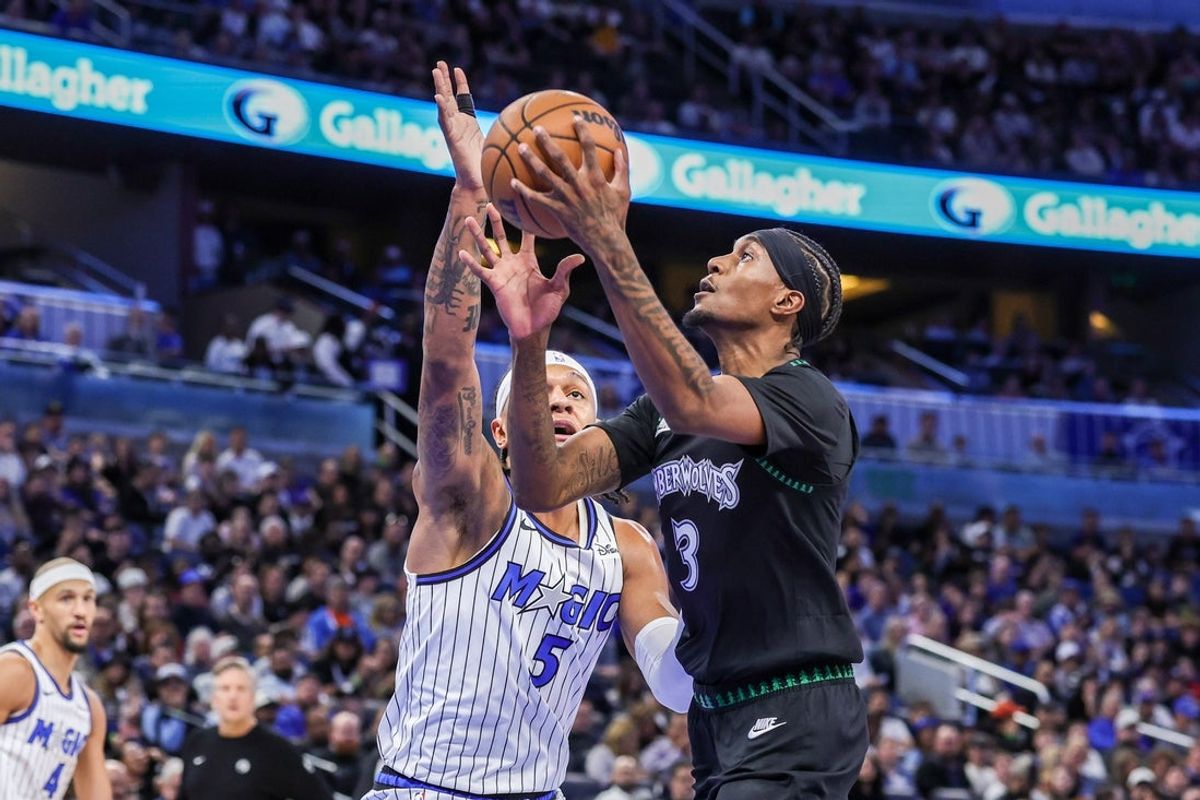 Apr 8, 2026; Orlando, Florida, USA; Minnesota Timberwolves forward Jaden McDaniels (3) goes to the basket against Orlando Magic forward Paolo Banchero (5) during the first quarter at Kia Center. Mandatory Credit: Mike Watters-Imagn Images
