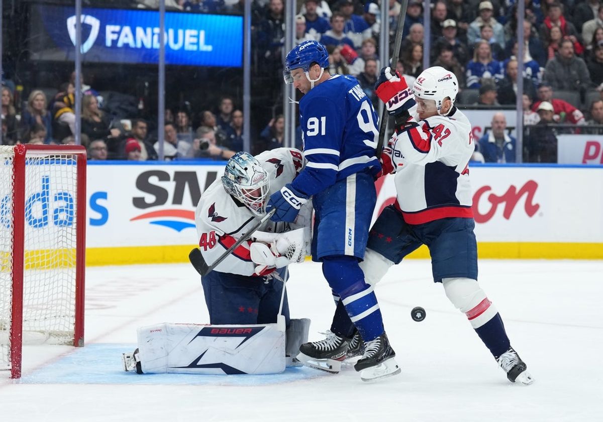 Apr 8, 2026; Toronto, Ontario, CAN; Toronto Maple Leafs center John Tavares (91) battles with Washington Capitals defenseman Martin Fehervary (42) in front of goaltender Logan Thompson (48) during the first period at Scotiabank Arena. Mandatory Credit: Nick Turchiaro-Imagn Images